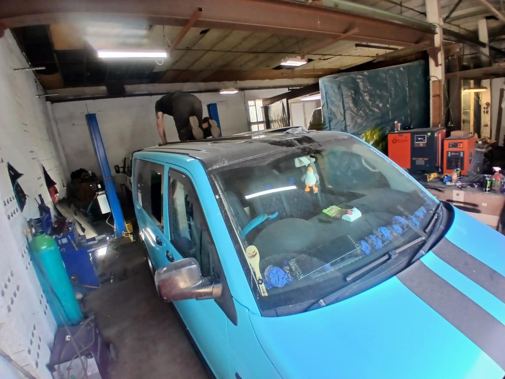 Front view of VW T5 during professional pop top roof installation at Kinmel Campers