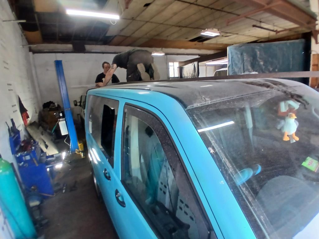 Cutting roof section of VW T5 for pop top conversion at Kinmel Campers