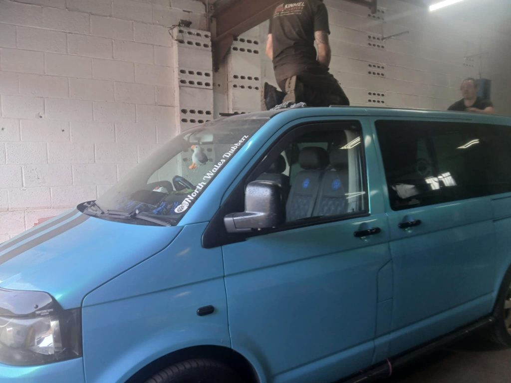 VW T5 pop top roof installation – technician preparing roof cut-out at Kinmel Campers workshop