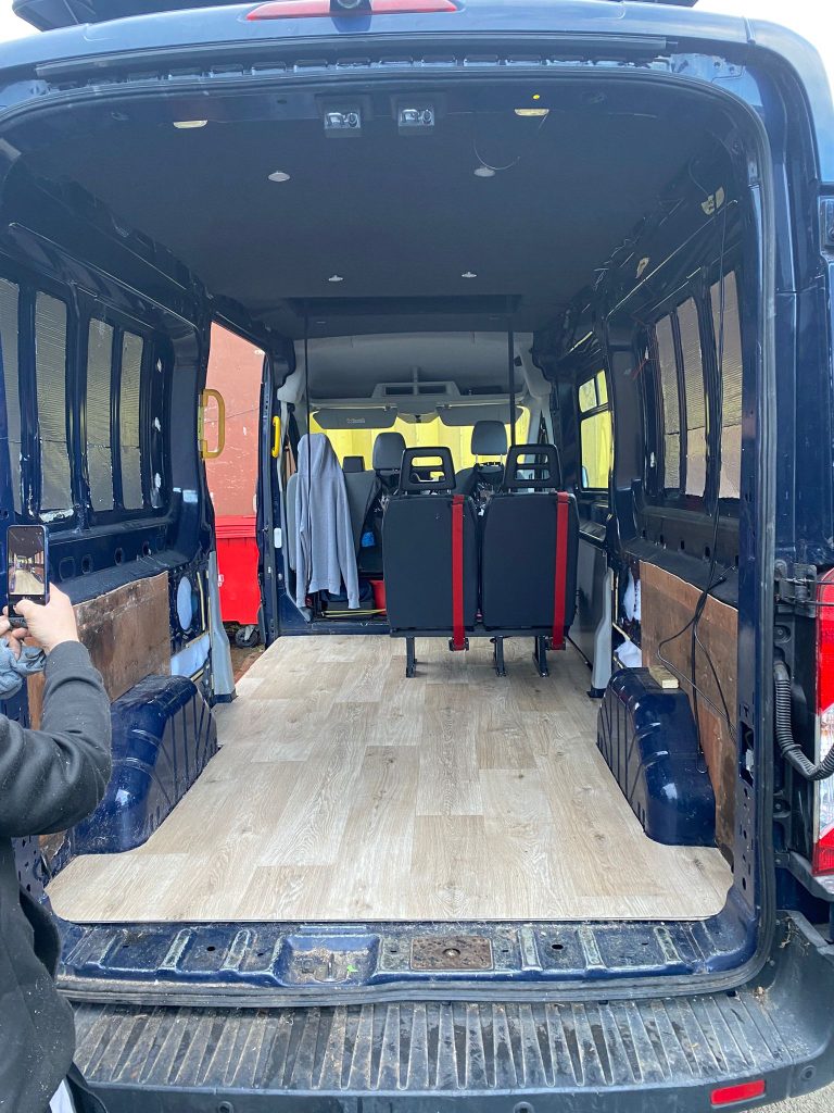 Rear seating installed in a Ford Transit Custom H2 after pop-top and flooring upgrades