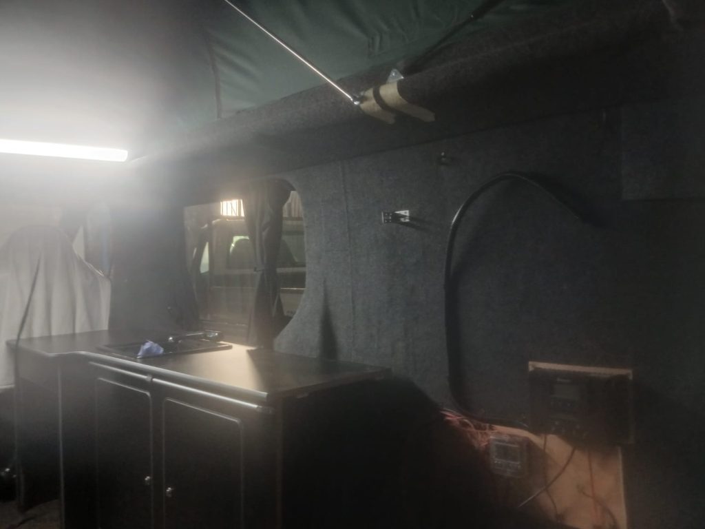 Kitchen unit and electrical system being reinstalled inside the Vauxhall Vivaro following pop-top roof fitting