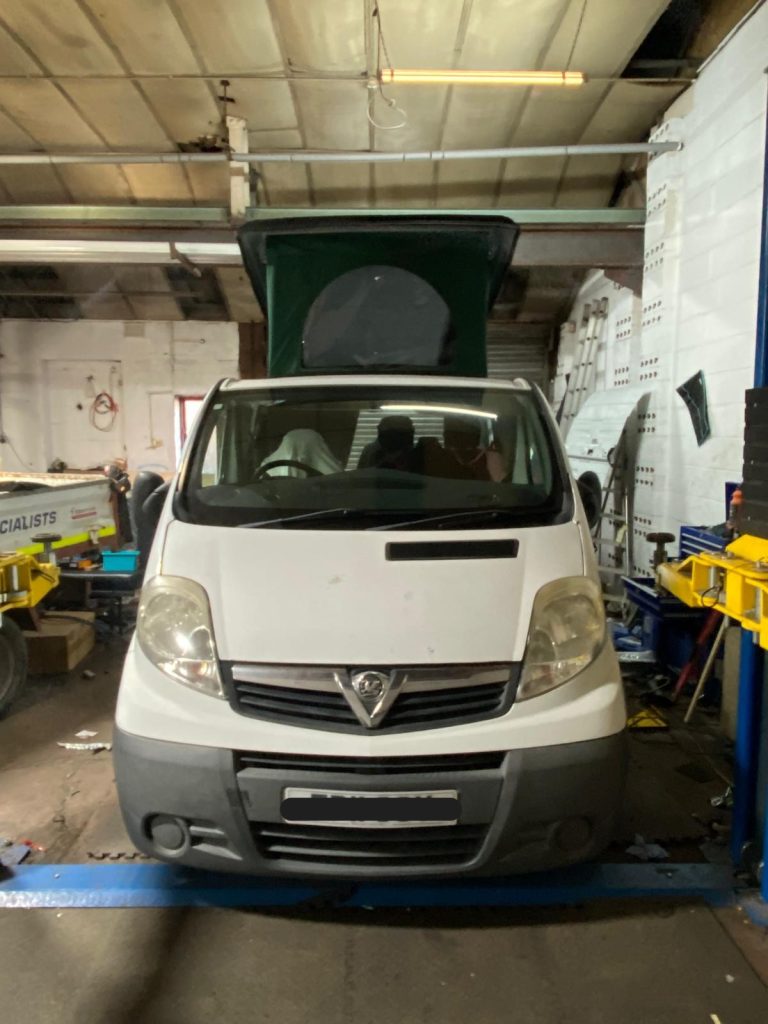 Vauxhall Vivaro pop-top roof raised, showing the front canvas window and completed roof structure