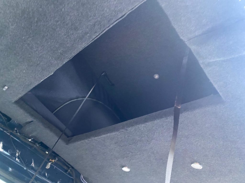 Custom fabricated steel pop-top hatch inside a Ford Transit Custom H2, designed for maximum safety and strength