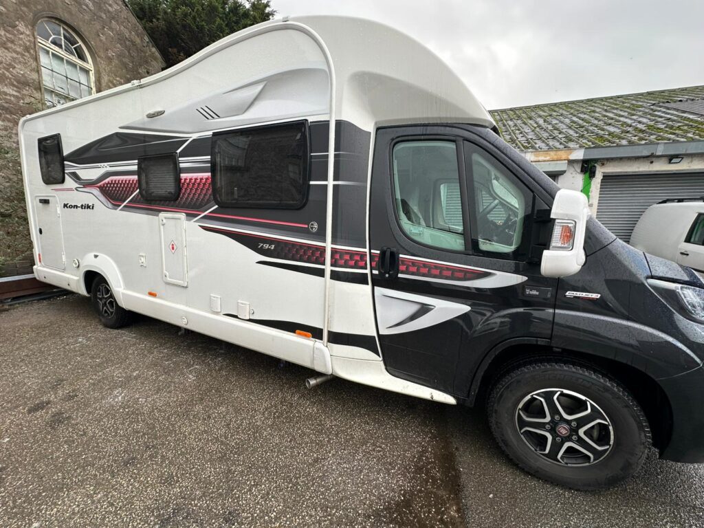 Side angle of Fiat Ducato Swift Kon-Tiki campervan on a rainy day at Kinmel Campers workshop in North Wales