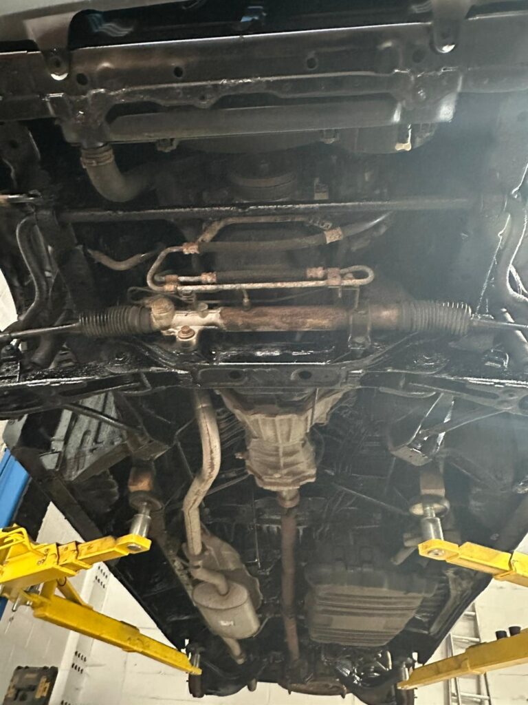 Campervan underseal service in progress with full underside inspection on vehicle lift