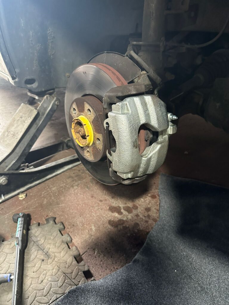 newly fitted VW T5 front brake caliper installed on disc