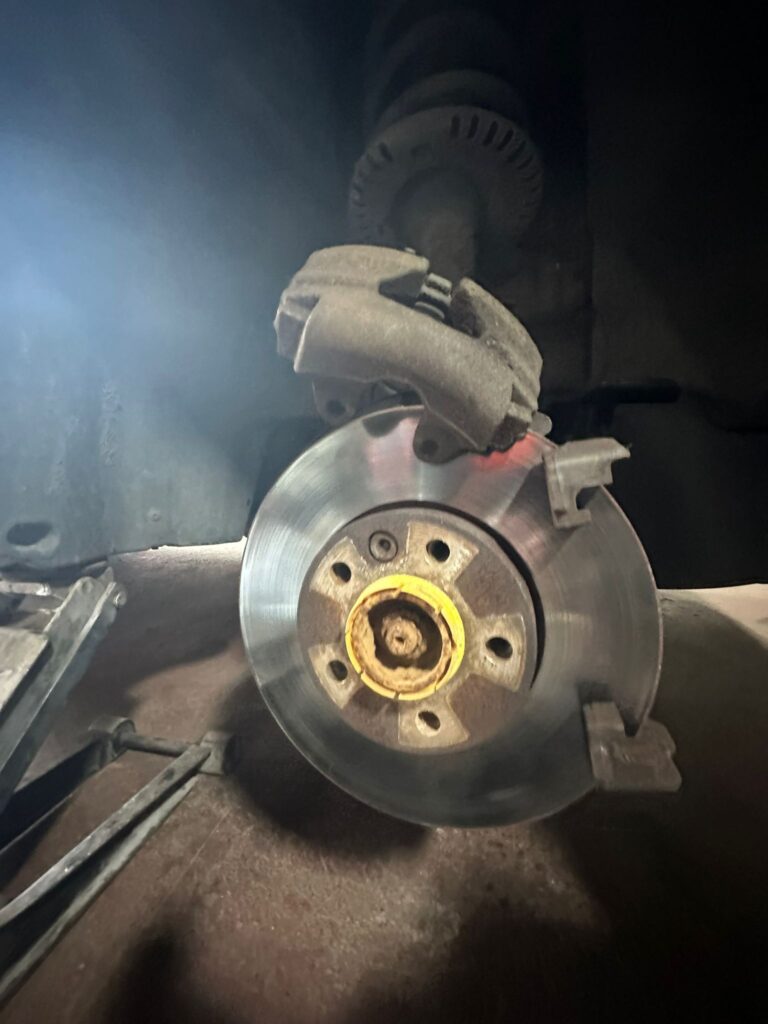 worn VW T5 front brake caliper and disc before replacement