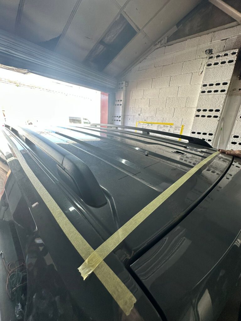 VW Caddy roof measured and taped for accurate pop top cut lines before installation at Kinmel Campers