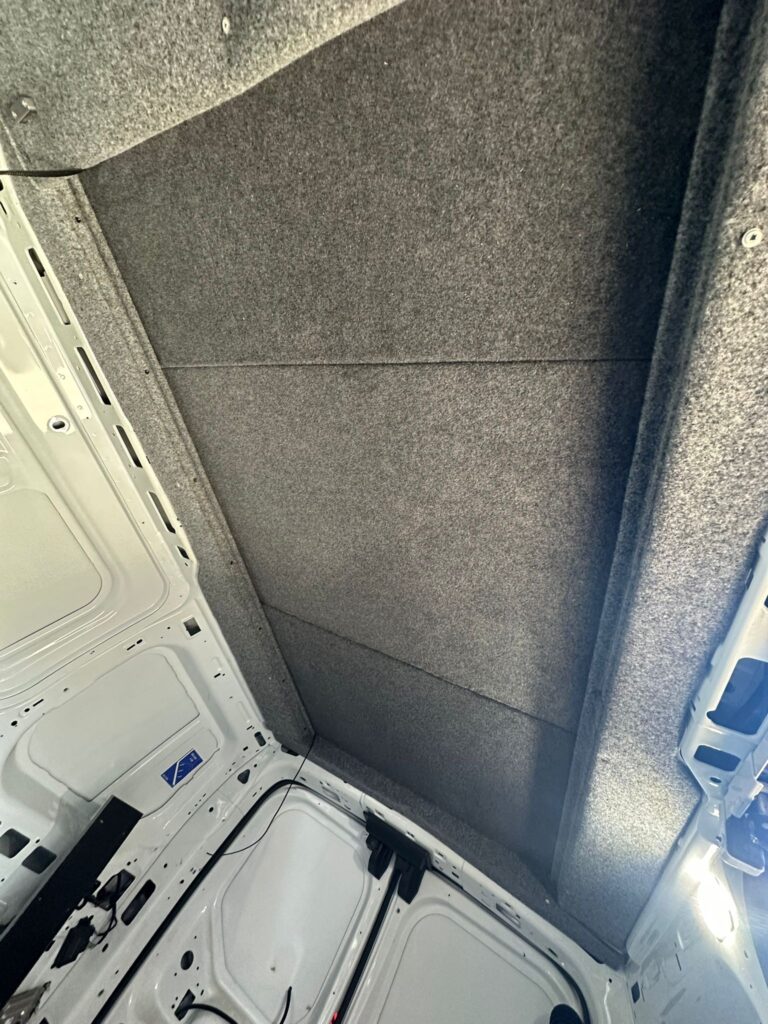 Finished Ford Transit Connect pop top roof interior with premium carpet lining by Kinmel Campers