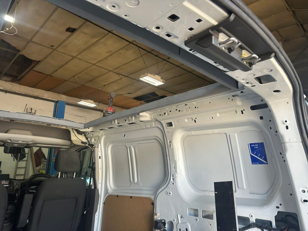 Custom structural reinforcement frame installed for Ford Transit Connect pop top roof conversion by Kinmel Campers