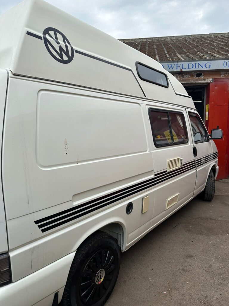 Rear side view of VW T4 campervan at Kinmel Campers for cambelt and water pump maintenance