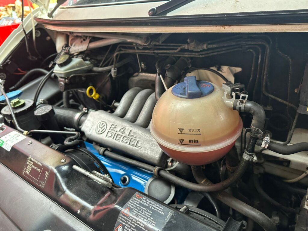 VW T4 2.4 diesel engine bay inspected during cam belt and water pump replacement at Kinmel Campers