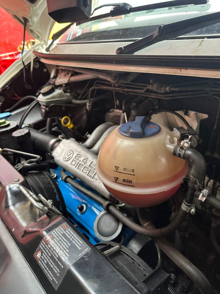 VW T4 2.4 diesel engine bay inspected during cam belt and water pump replacement at Kinmel Campers
