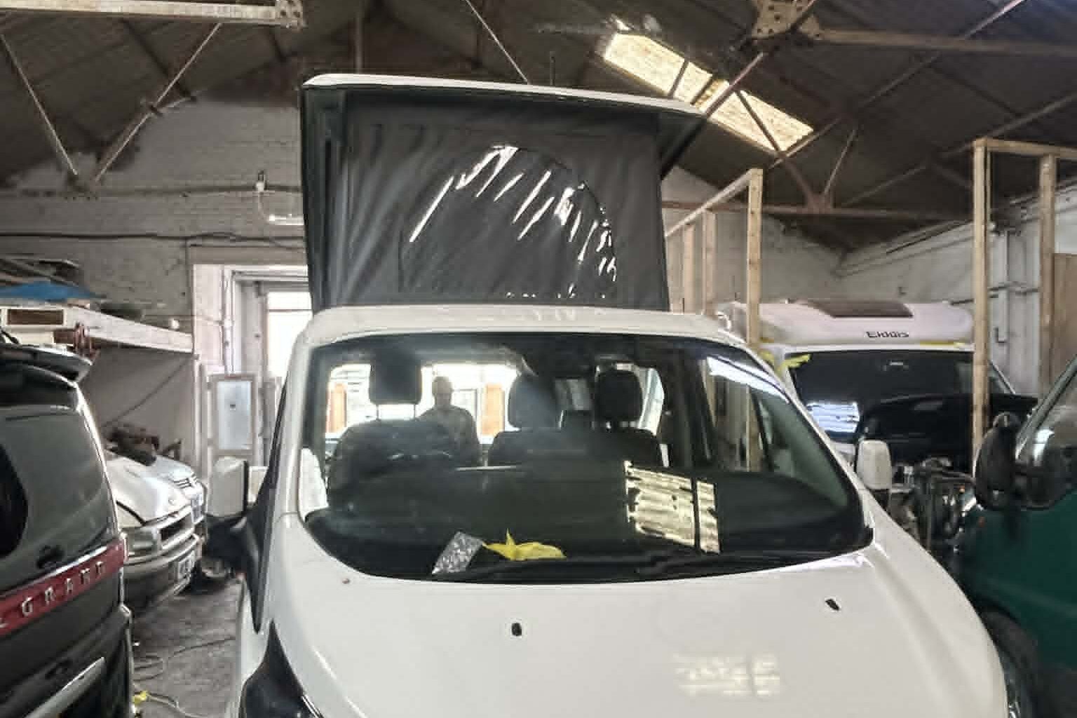 Ford Transit Custom campervan with pop top roof raised after professional installation