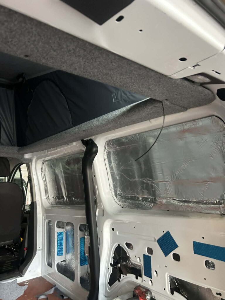 Ford Transit Custom pop top roof raised showing grey canvas and newly installed elevating roof system