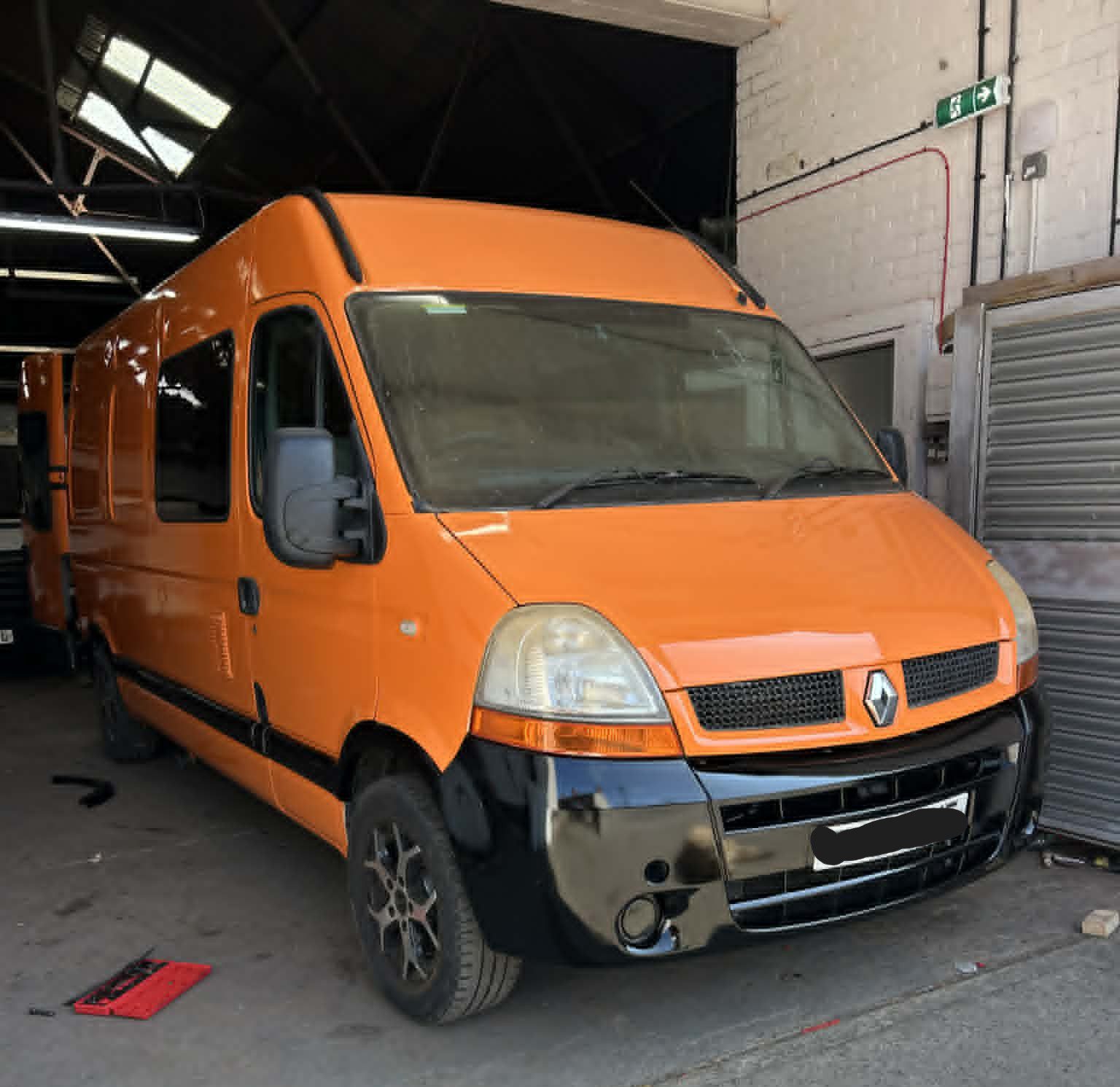 Bright orange campervan respray North Wales with gloss black trims after workshop repair