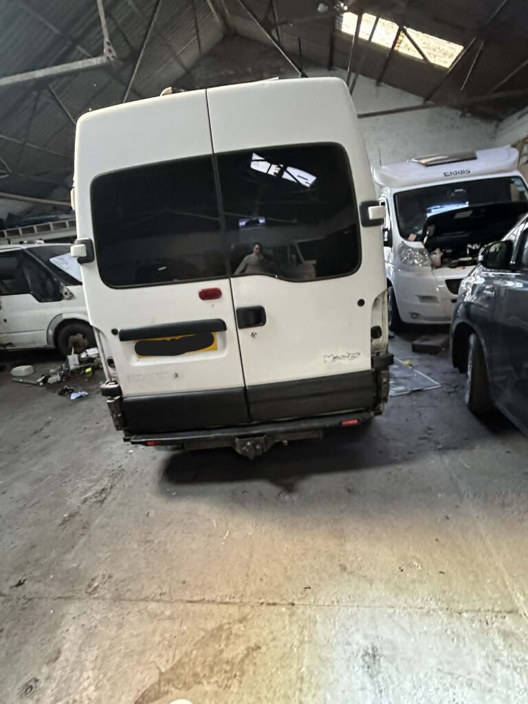 Rear view of white campervan before full respray and exterior repairs