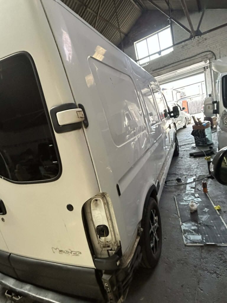 Side view of white campervan before orange paintwork transformation